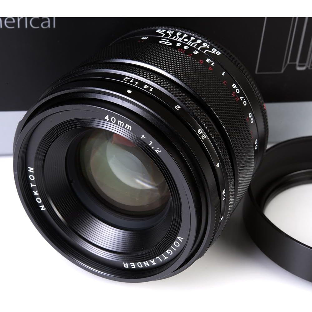 Black Voigtlander Nokton 40mm f/1.2 lens with aperture and distance markings. Lens cap nearby.