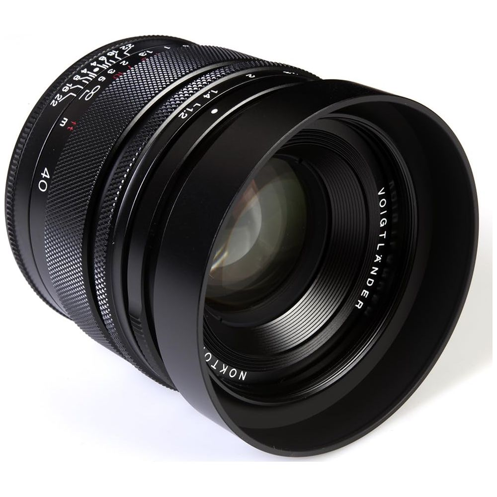 Black camera lens with focus and aperture rings, on a white background.