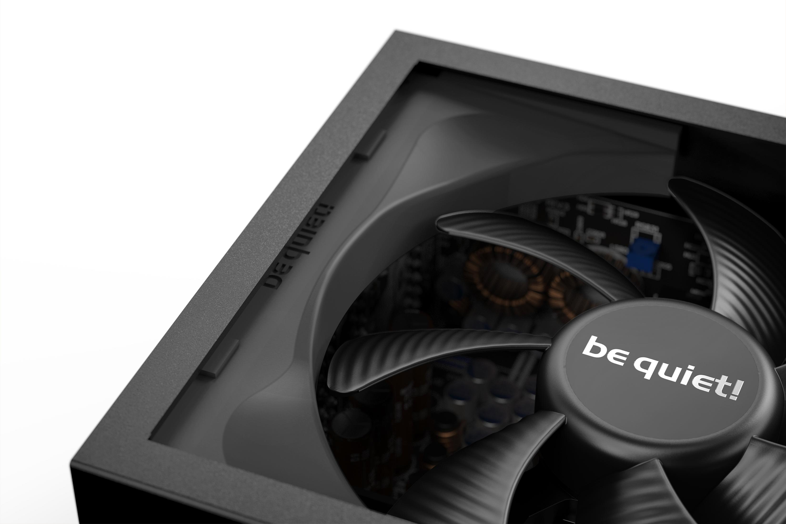 Close-up van een zwarte computer ventilator met 'be quiet!' logo en interne componenten.