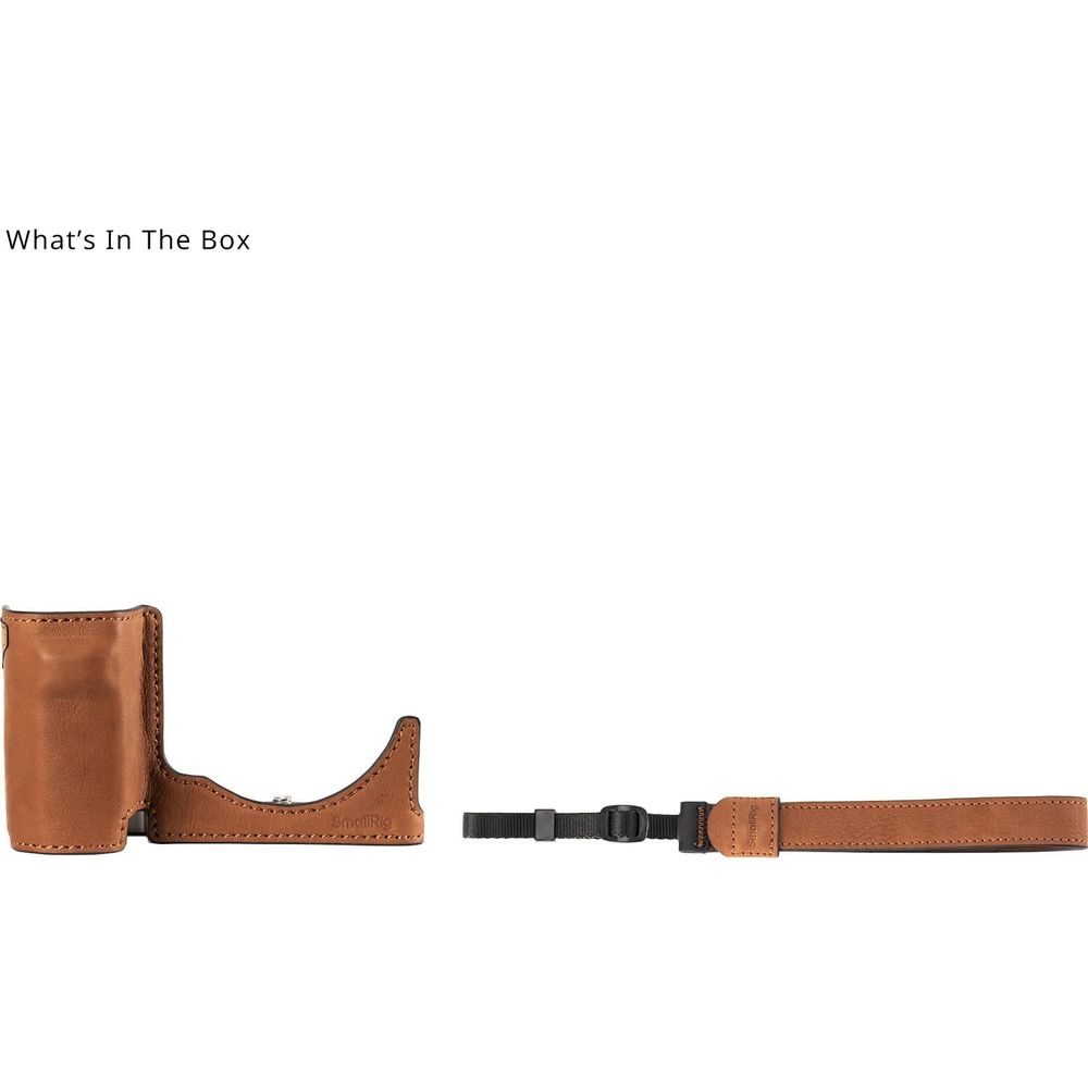 A brown leather camera grip and a strap with a black clip.