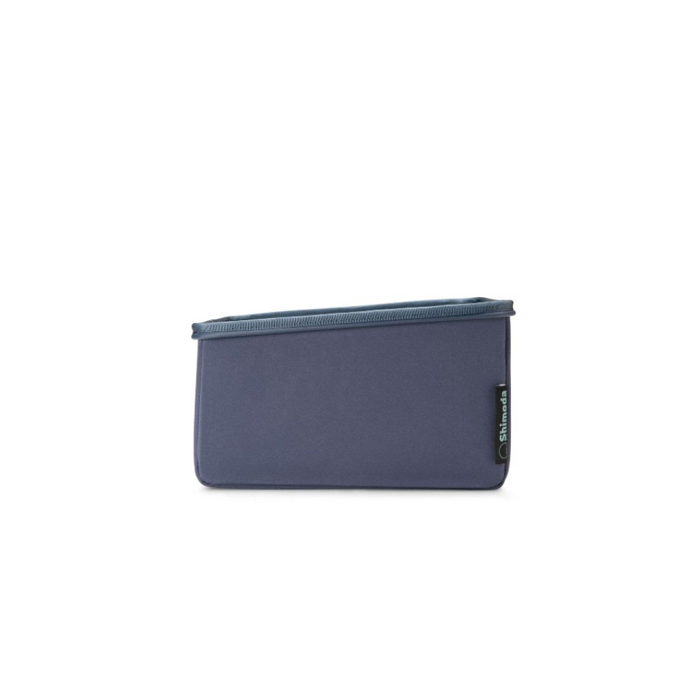 A gray-blue Shimoda bag with a teal rim.