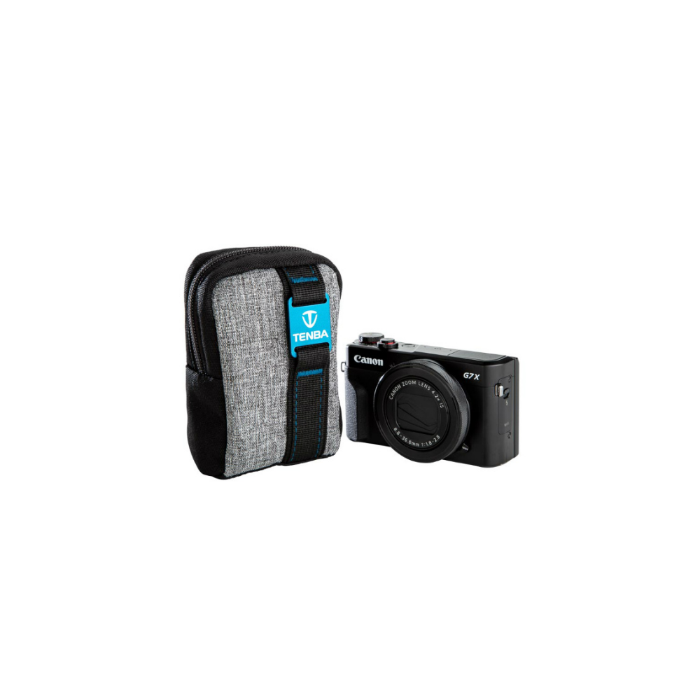 Gray camera case with blue strap and black Canon camera beside it.