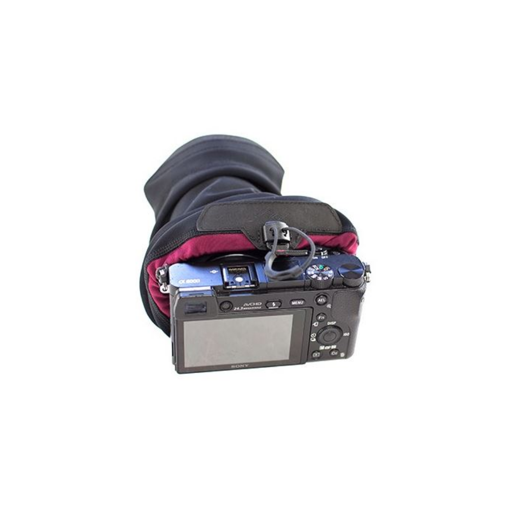 A black camera bag protects a Sony Alpha 6000 camera from the cold.