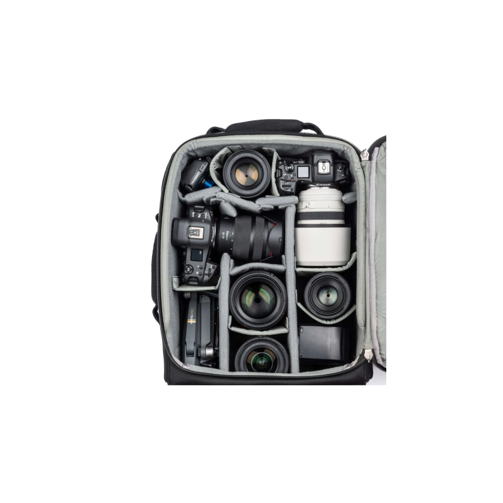 A black camera bag is open, revealing organized camera gear: lenses, cameras, and a drone.