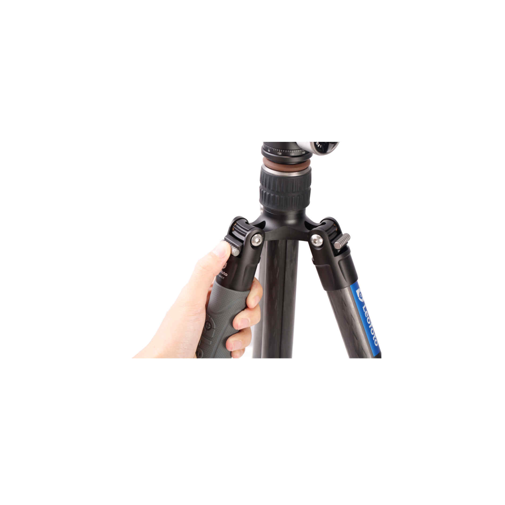 A hand holding a part of a tripod with a lock.