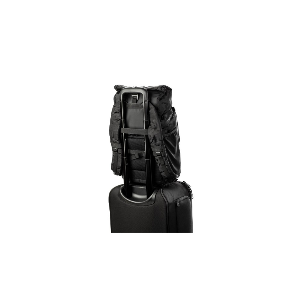 Black backpack on a rolling suitcase, with an extendable handle.