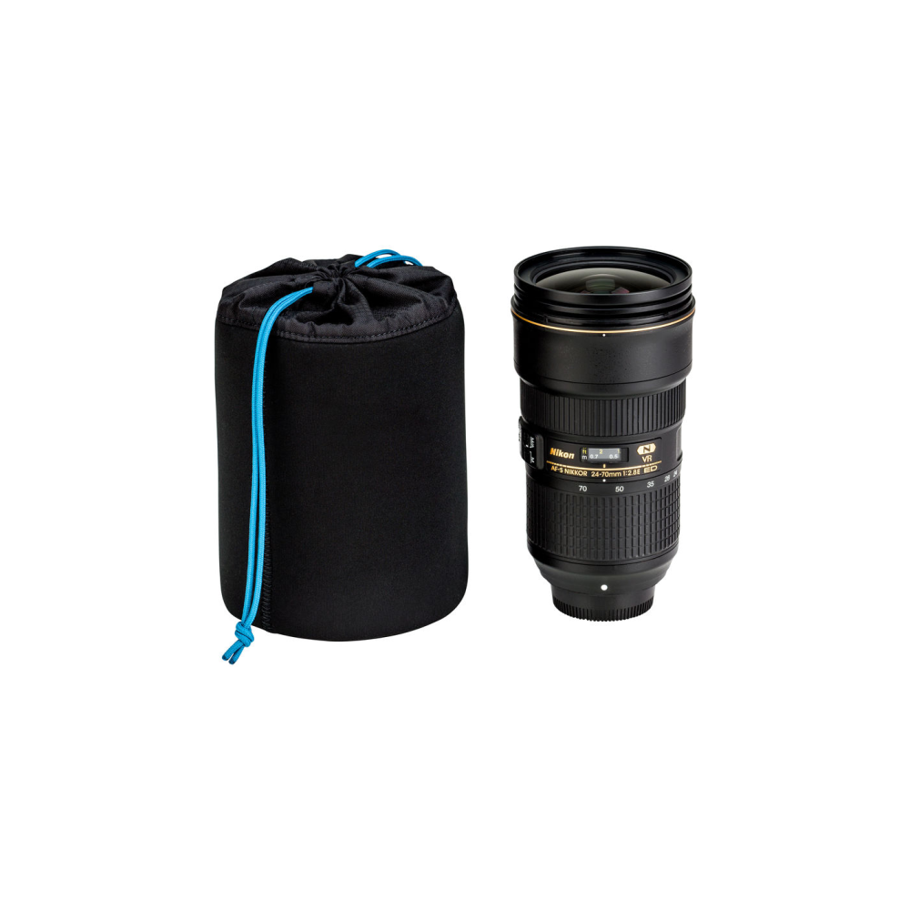 A black lens pouch with a blue drawstring sits next to a Nikon camera lens.