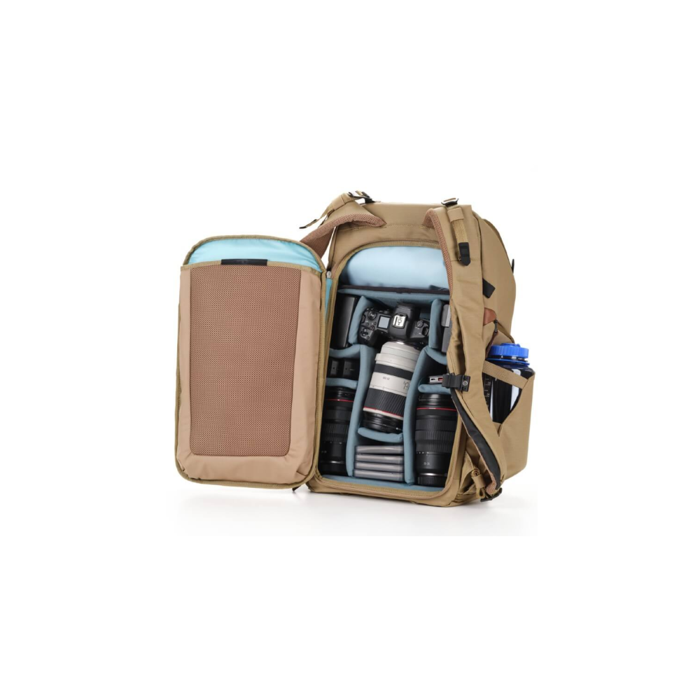 A tan camera backpack with an open compartment, filled with cameras and lenses.