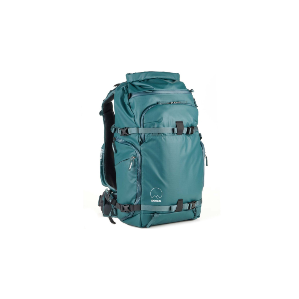 A teal backpack with multiple pockets and straps, isolated on a white background.