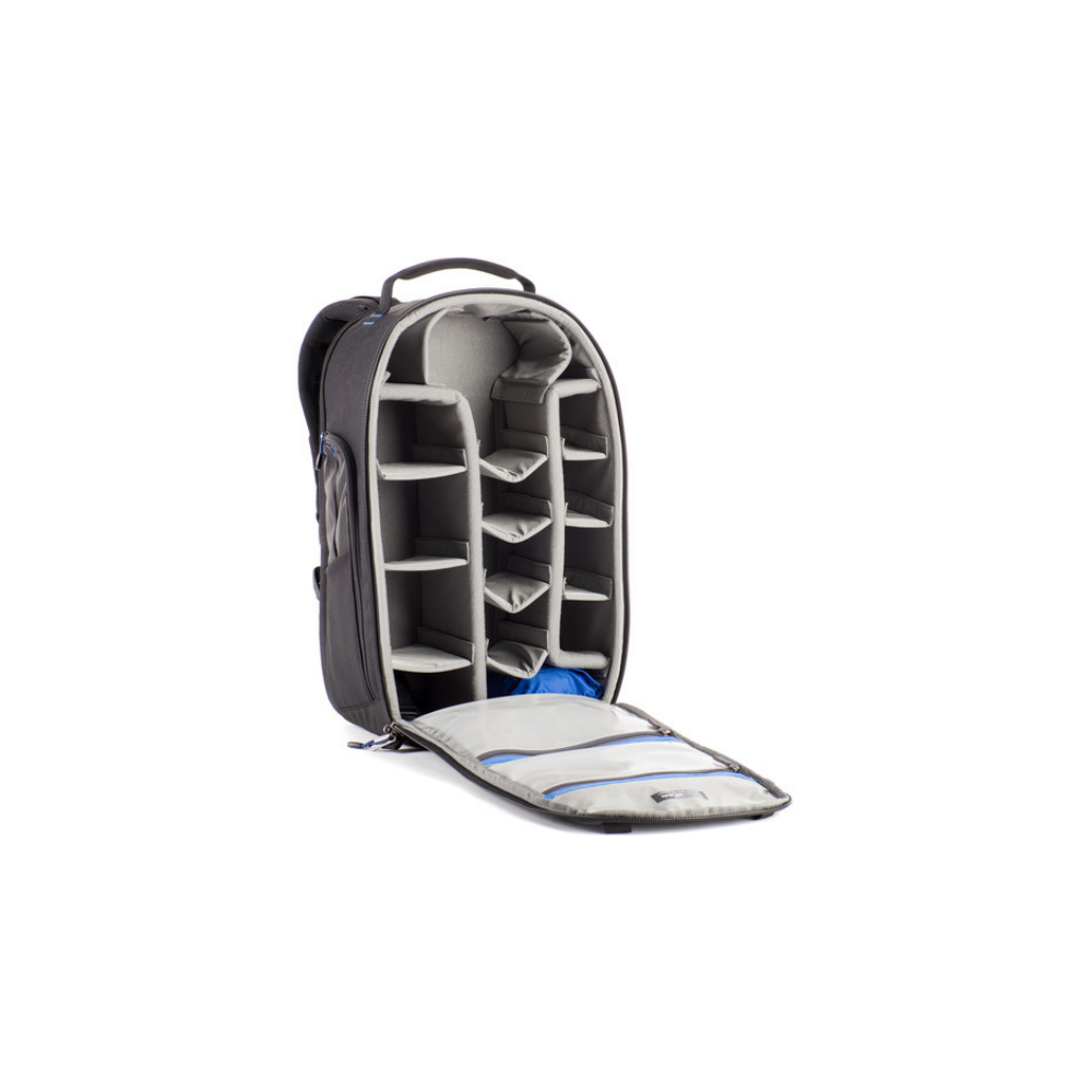 An open black camera backpack with padded dividers and a blue interior lining.