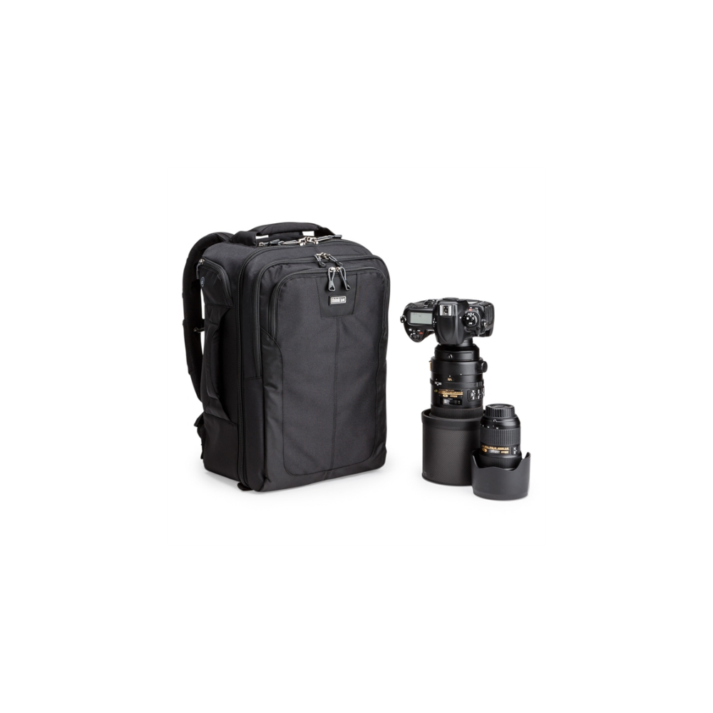 Black backpack with a digital camera and lenses.