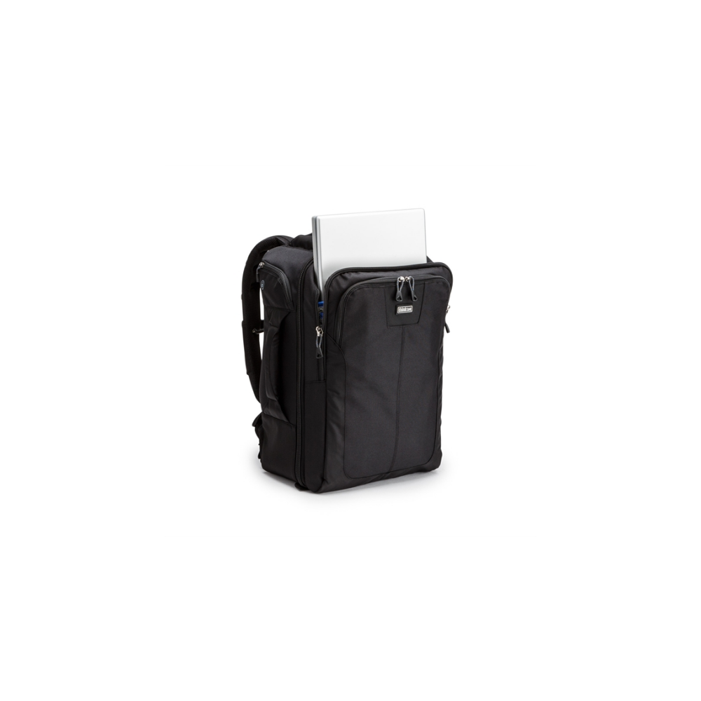 A black backpack with a laptop partially sticking out.
