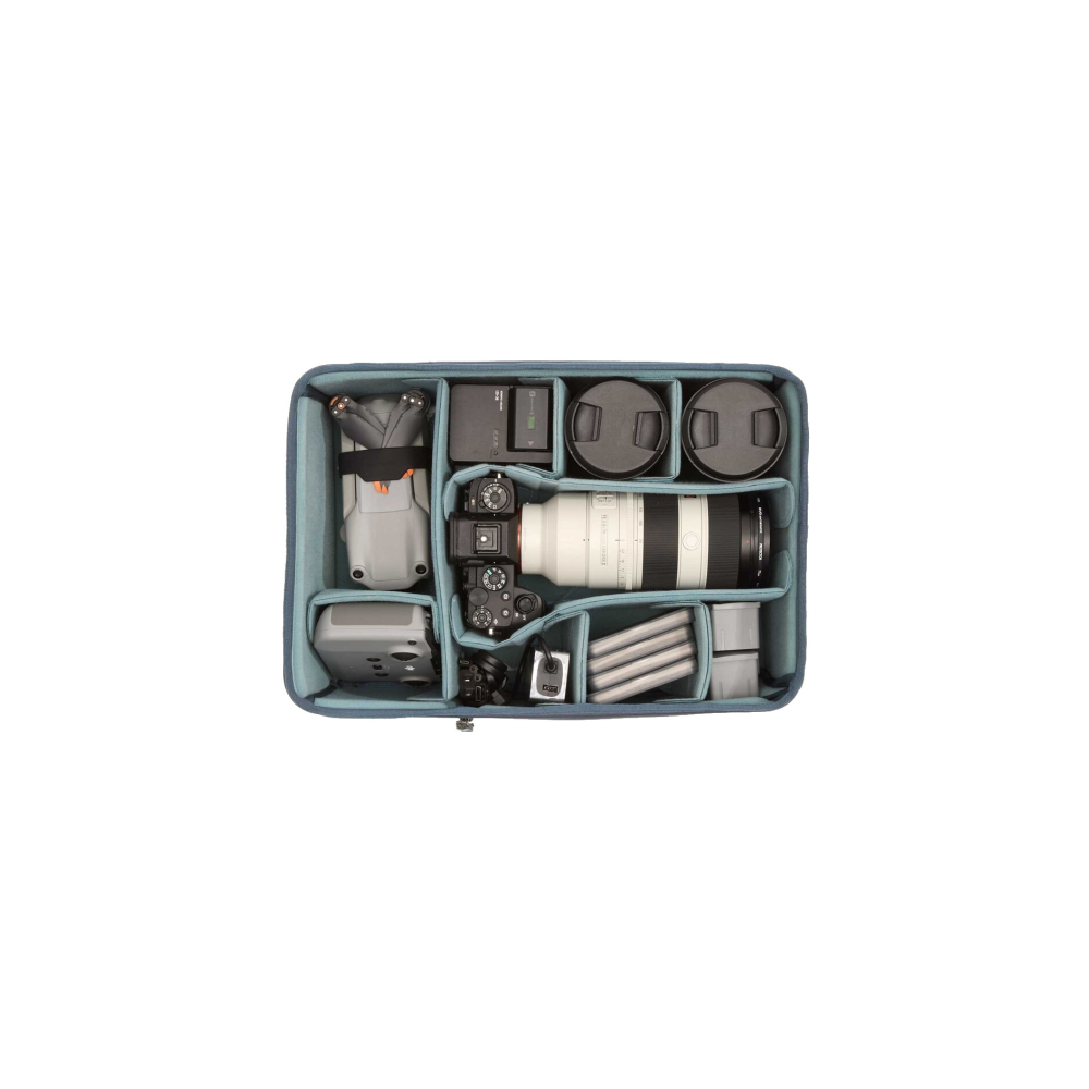 A camera bag with a drone, cameras, lenses, and accessories.