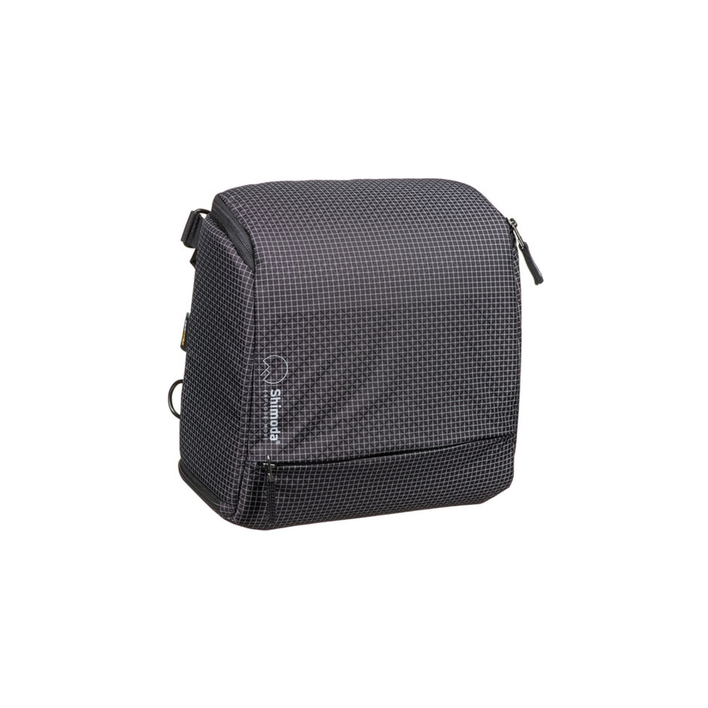 A gray Shimoda bag with a checkered pattern and zippers.