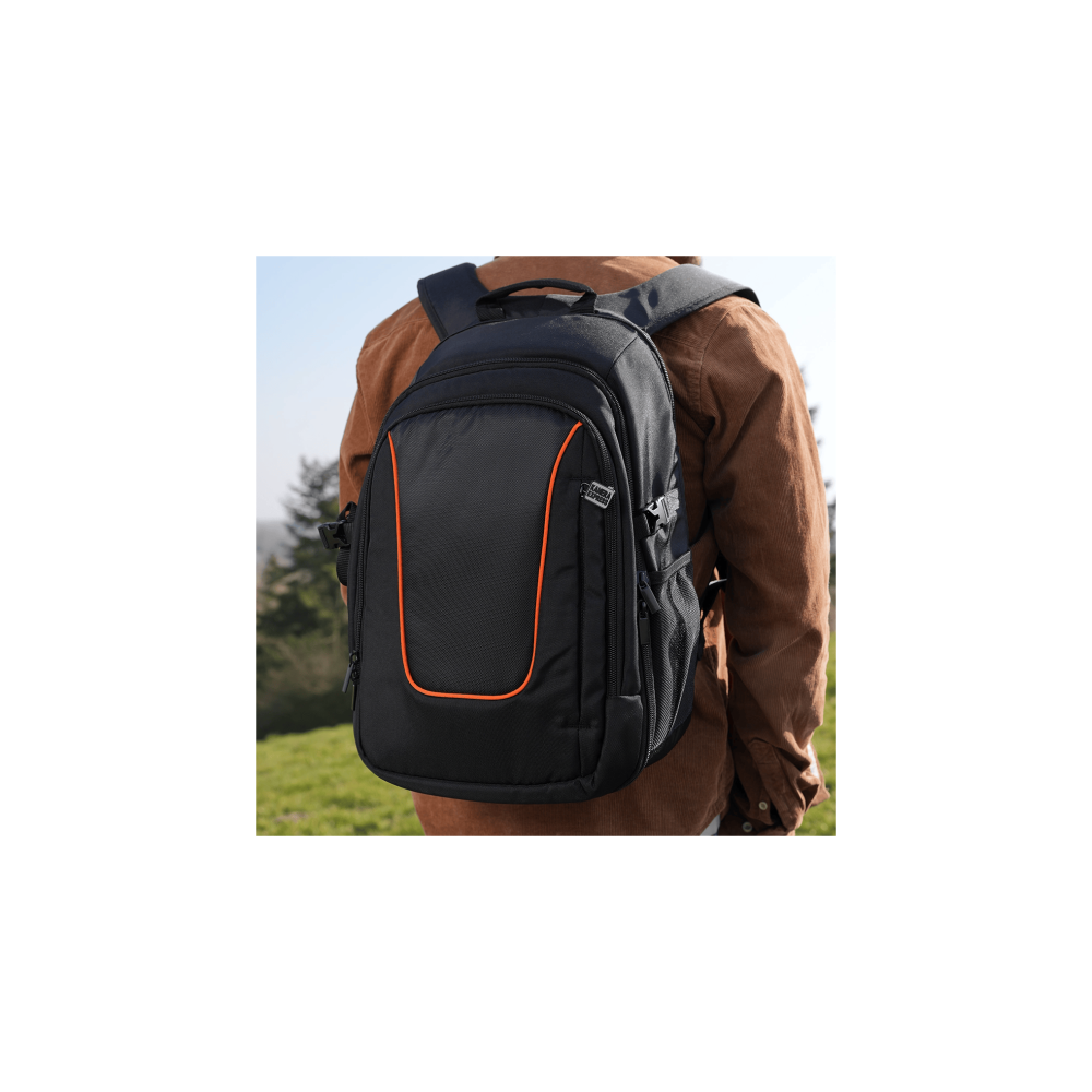A black backpack with orange accents, worn by a person in a brown jacket, outdoors.