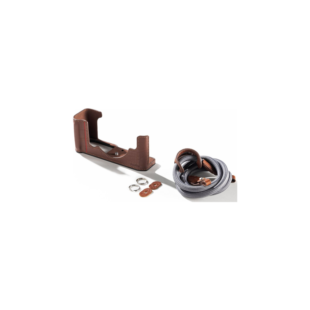 Brown leather camera case, two rings, and a grey camera strap.