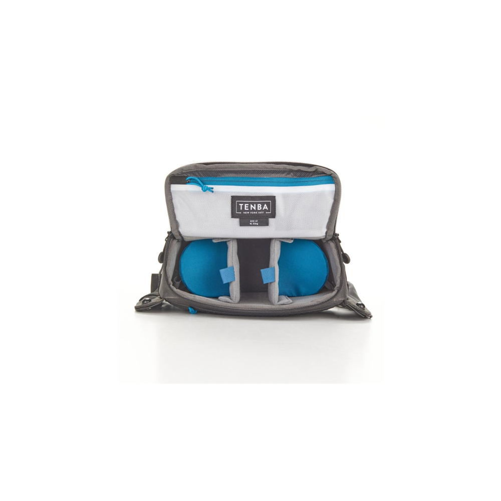 Gray Tenba bag with open compartment, two blue spheres and white interior.