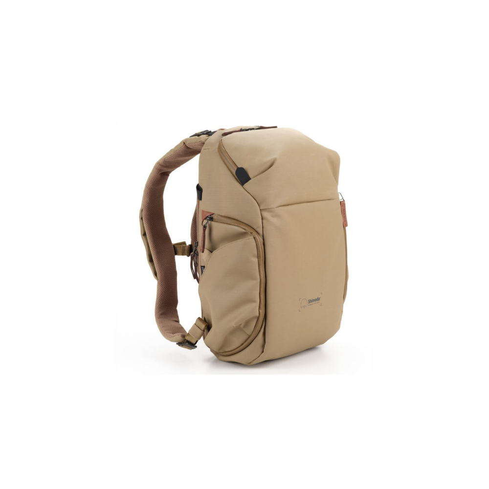 A tan backpack with brown straps, shown against a white background.