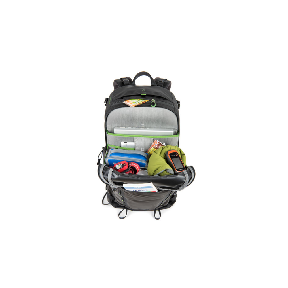 An open backpack with a laptop, headphones, GPS device, and clothing inside.
