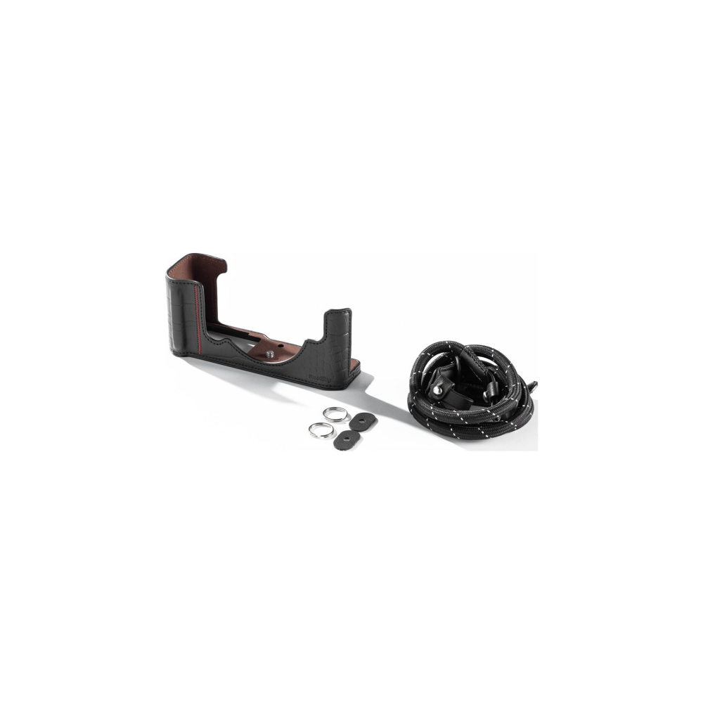 Black leather camera case with strap and rings.