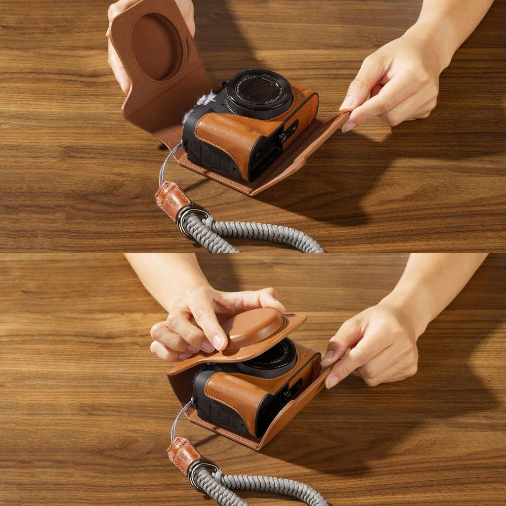 Hands assembling a brown leather camera case on a wooden table.