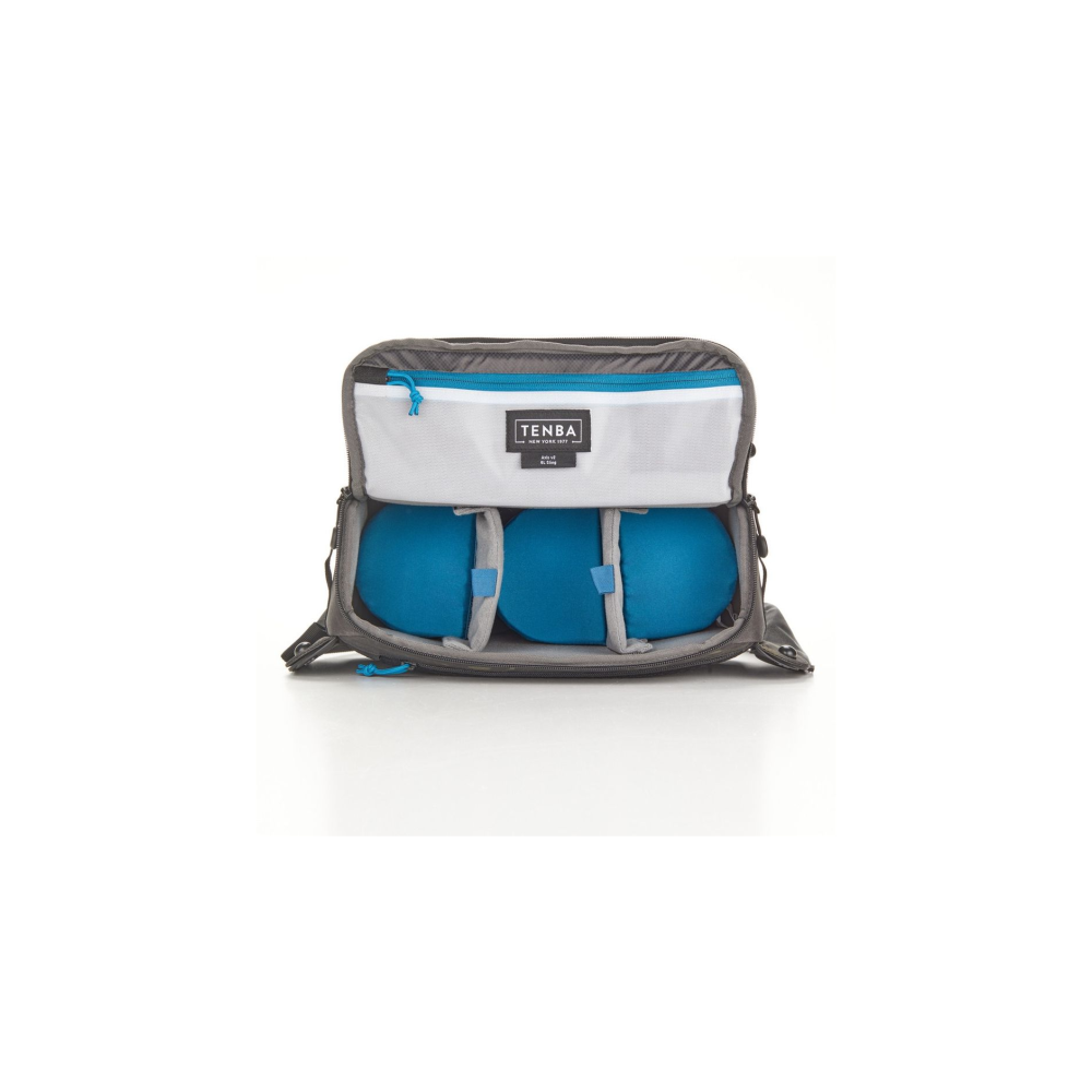 Gray bag with blue balls and a white mesh compartment with Tenba logo.