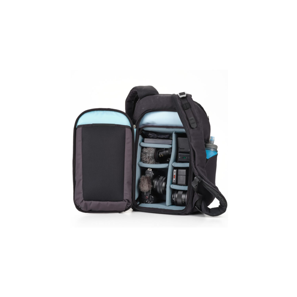 A black backpack with cameras, microphones, and a water bottle inside.