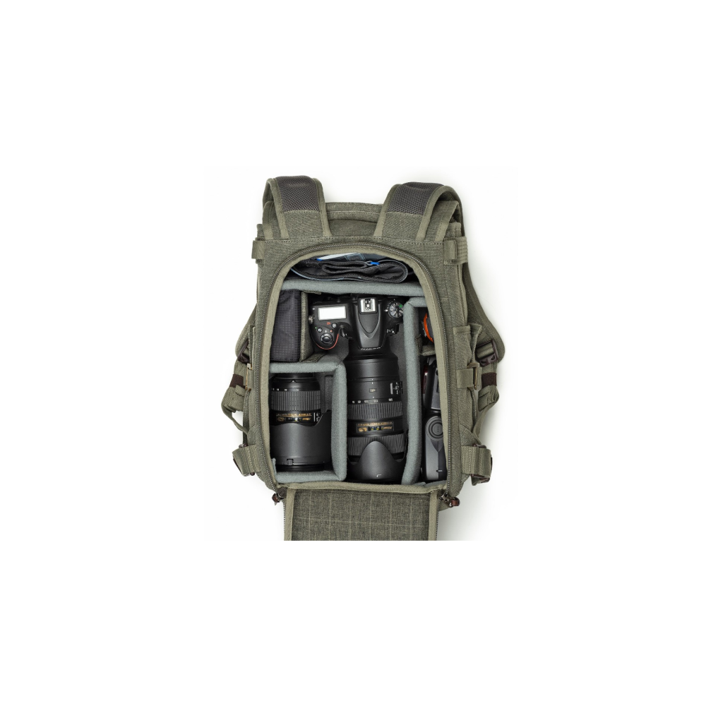 A green backpack with cameras and lenses arranged in its compartments.
