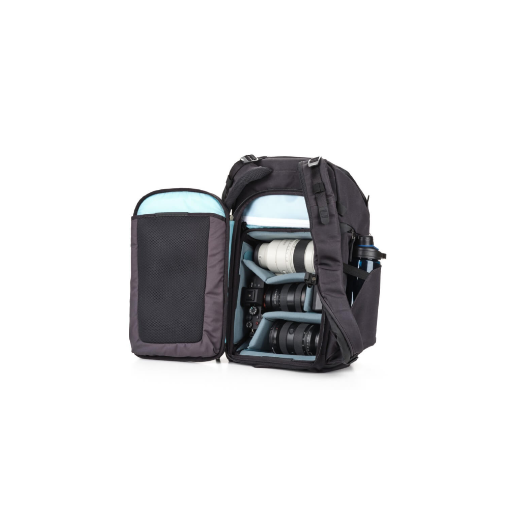Black backpack with an open compartment, holding camera lenses and a water bottle.