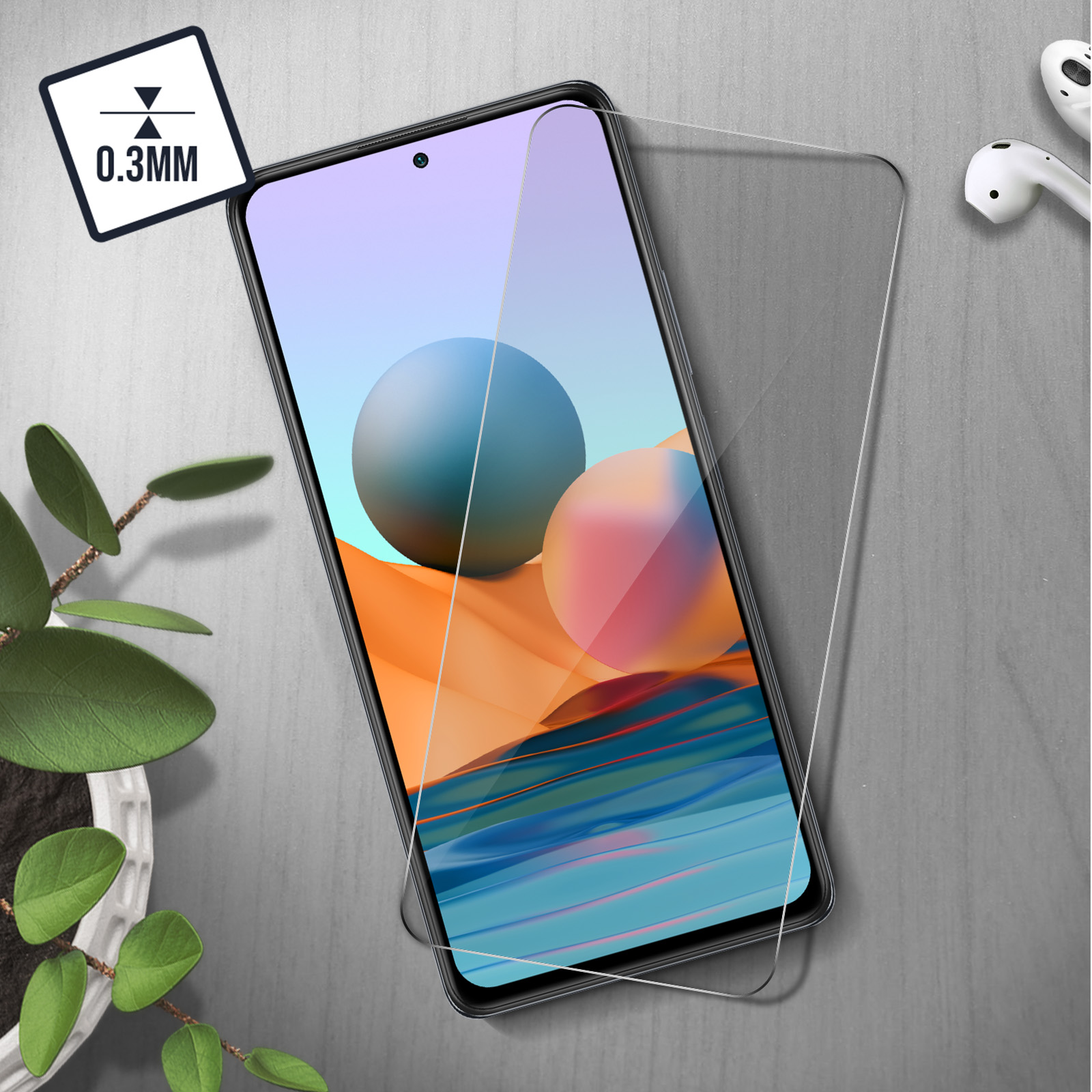 Un teléfono inteligente con protector de pantalla, auriculares y planta.