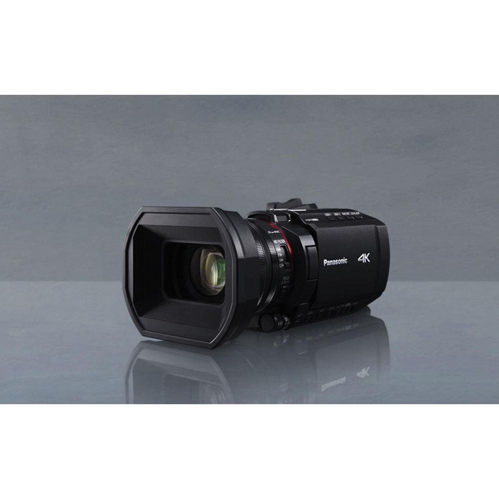 Czarna kamera Panasonic 4K z wizjerem i obiektywem na odblaskowej powierzchni.