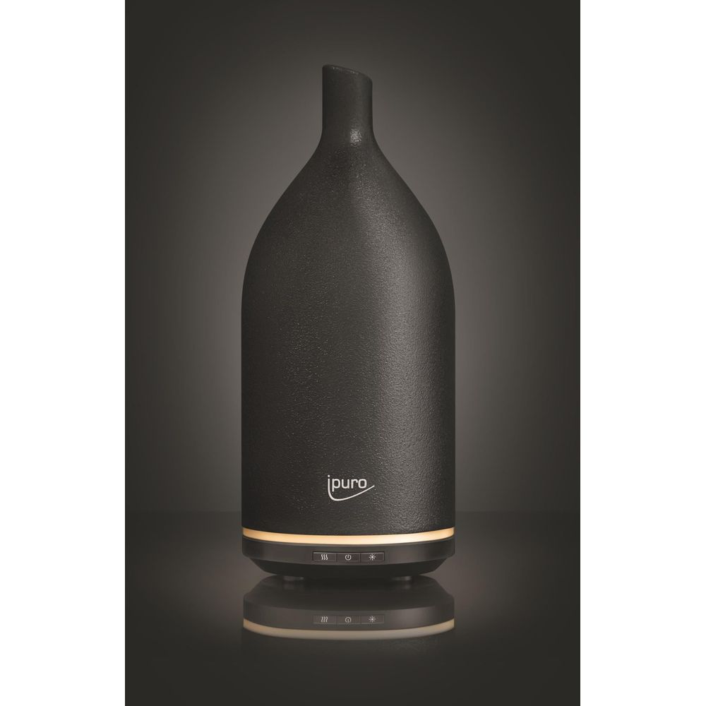 Un diffusore nero e moderno con collo stretto e base illuminata.