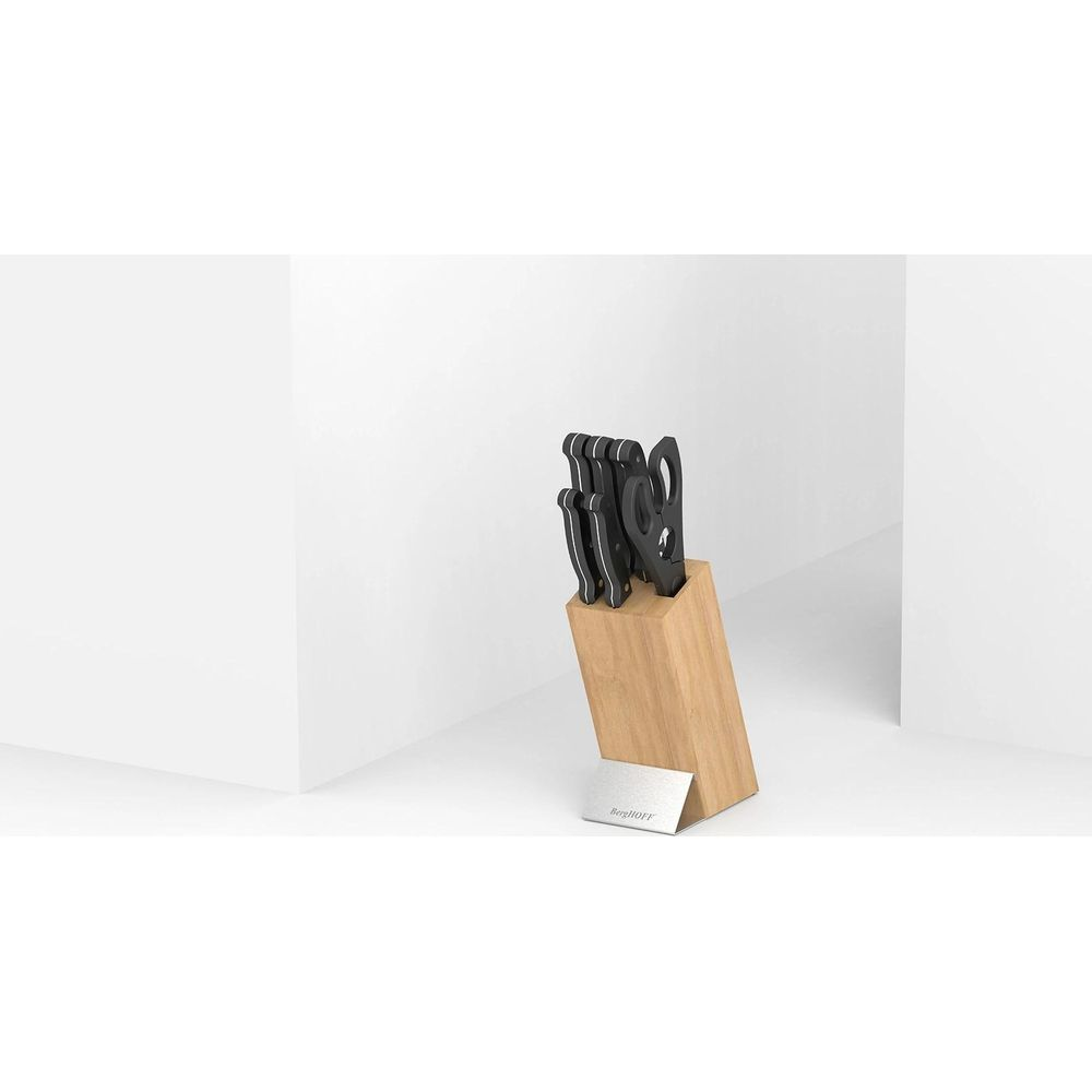 A wooden block holding knives with a BergHOFF logo.