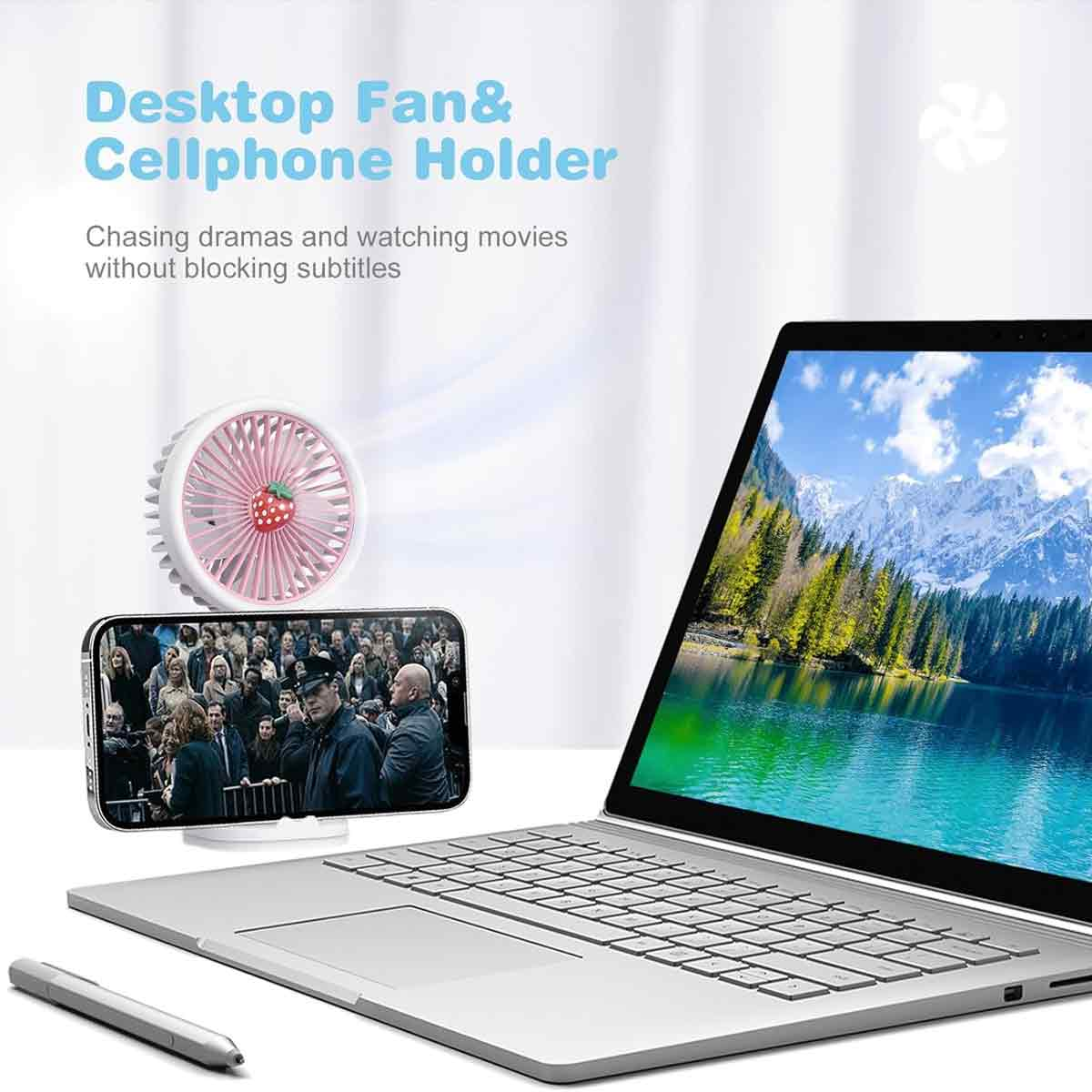 Laptop mit Bergsee-Bild, Handy zeigt Film, und Erdbeer-Ventilator.
