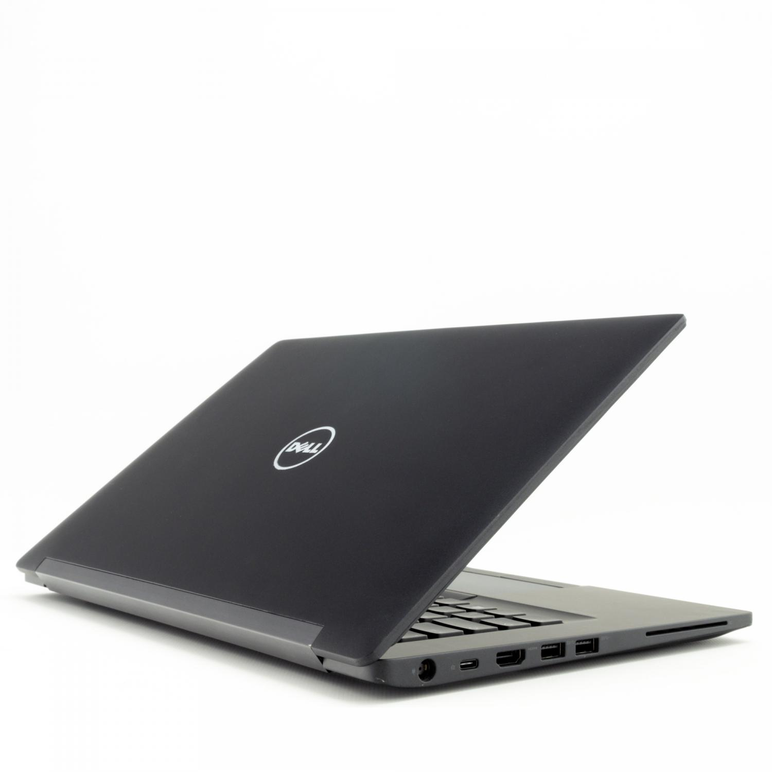 Ein geschlossener schwarzer Dell Laptop mit beleuchtetem Logo auf dem Deckel.
