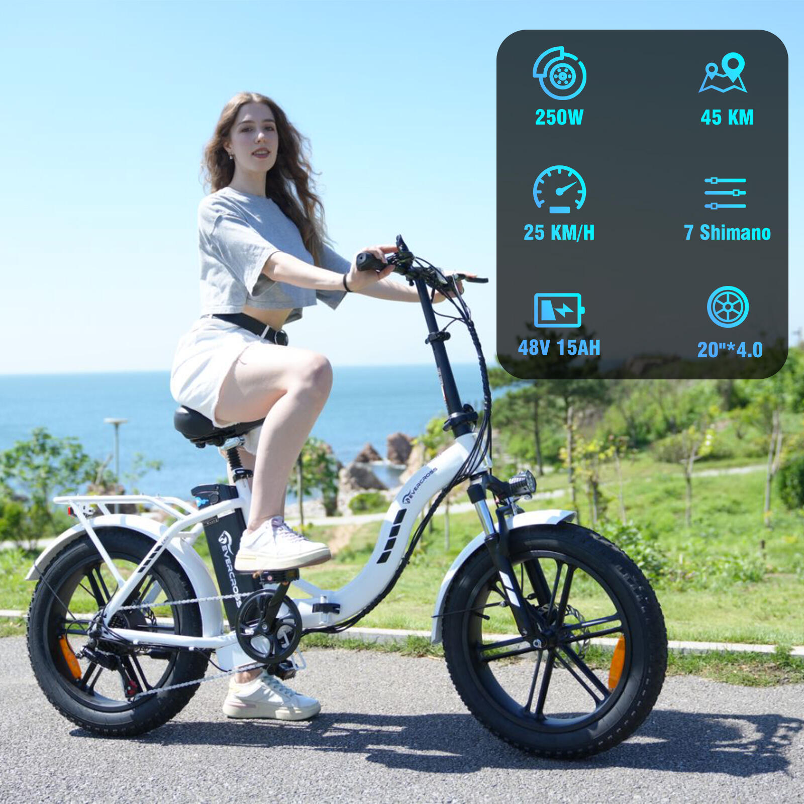 Een vrouw op een witte elektrische fiets met dikke banden bij de zee.