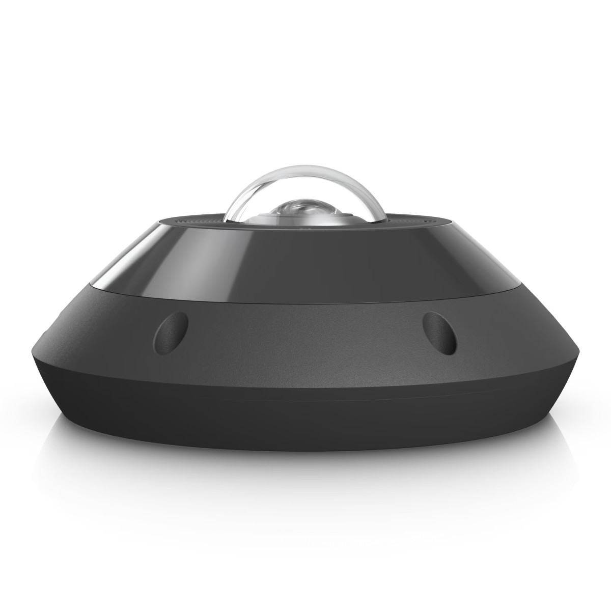 A gray, disc-shaped device with a clear dome on top sits on a white surface.