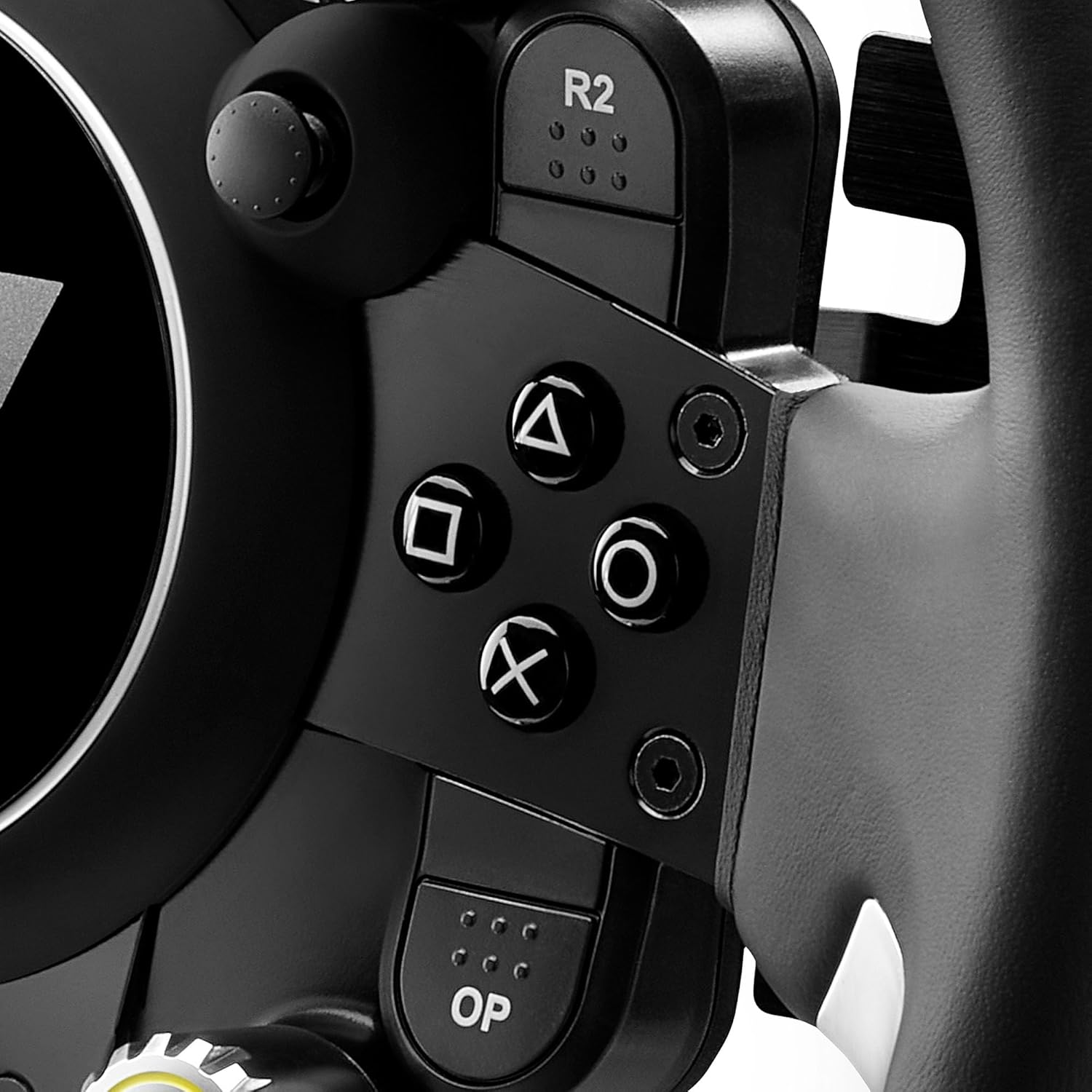 Close-up of a black gaming steering wheel with buttons and a joystick.