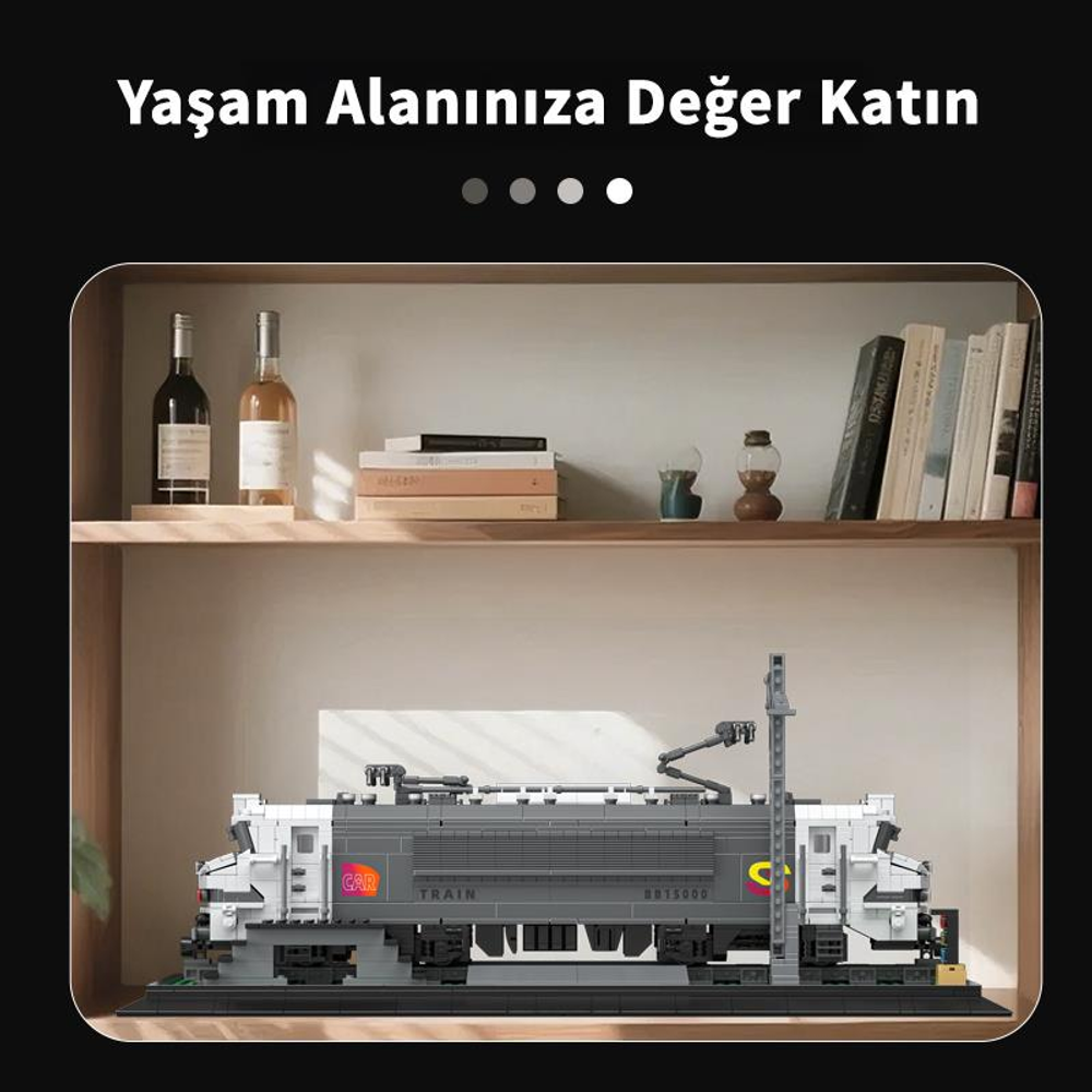 Gri ve beyaz bir lokomotifin detaylı modeli, kitaplar ve şişelerin yanında rafta duruyor.