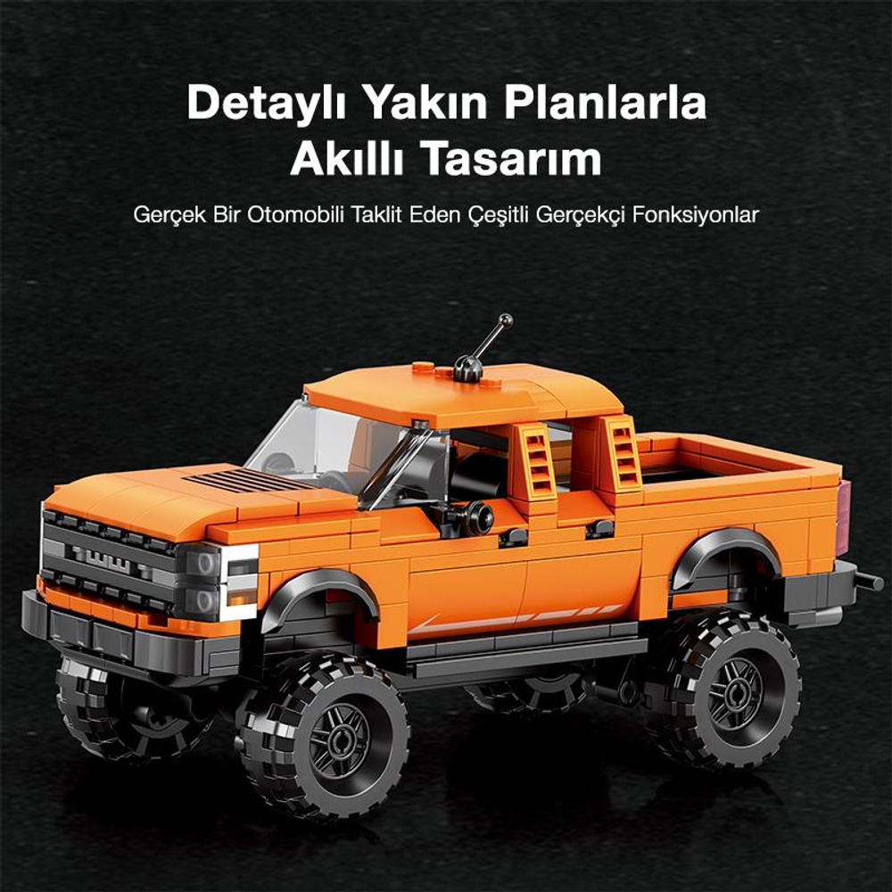 Siyah tekerlekli turuncu bir LEGO kamyonet karanlık bir zeminde duruyor.