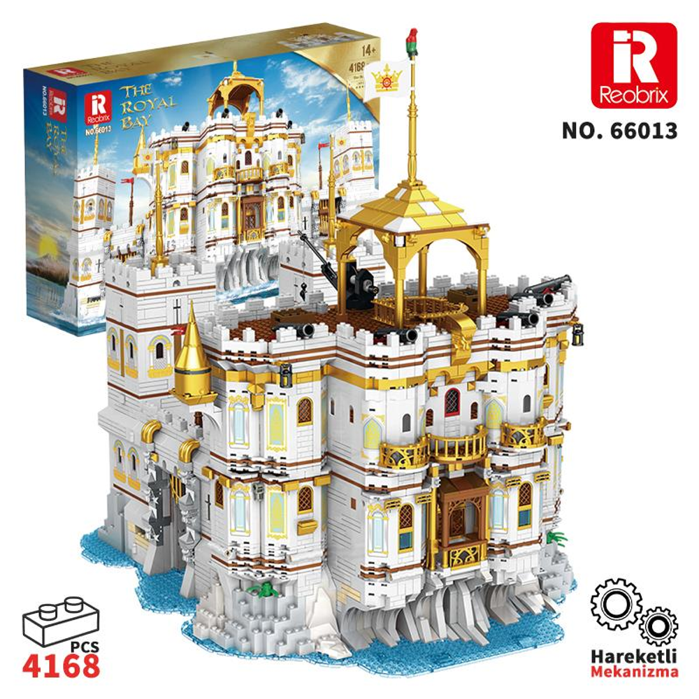 Kayalar üzerinde beyaz ve altın Lego kale, yanında bir kutu.