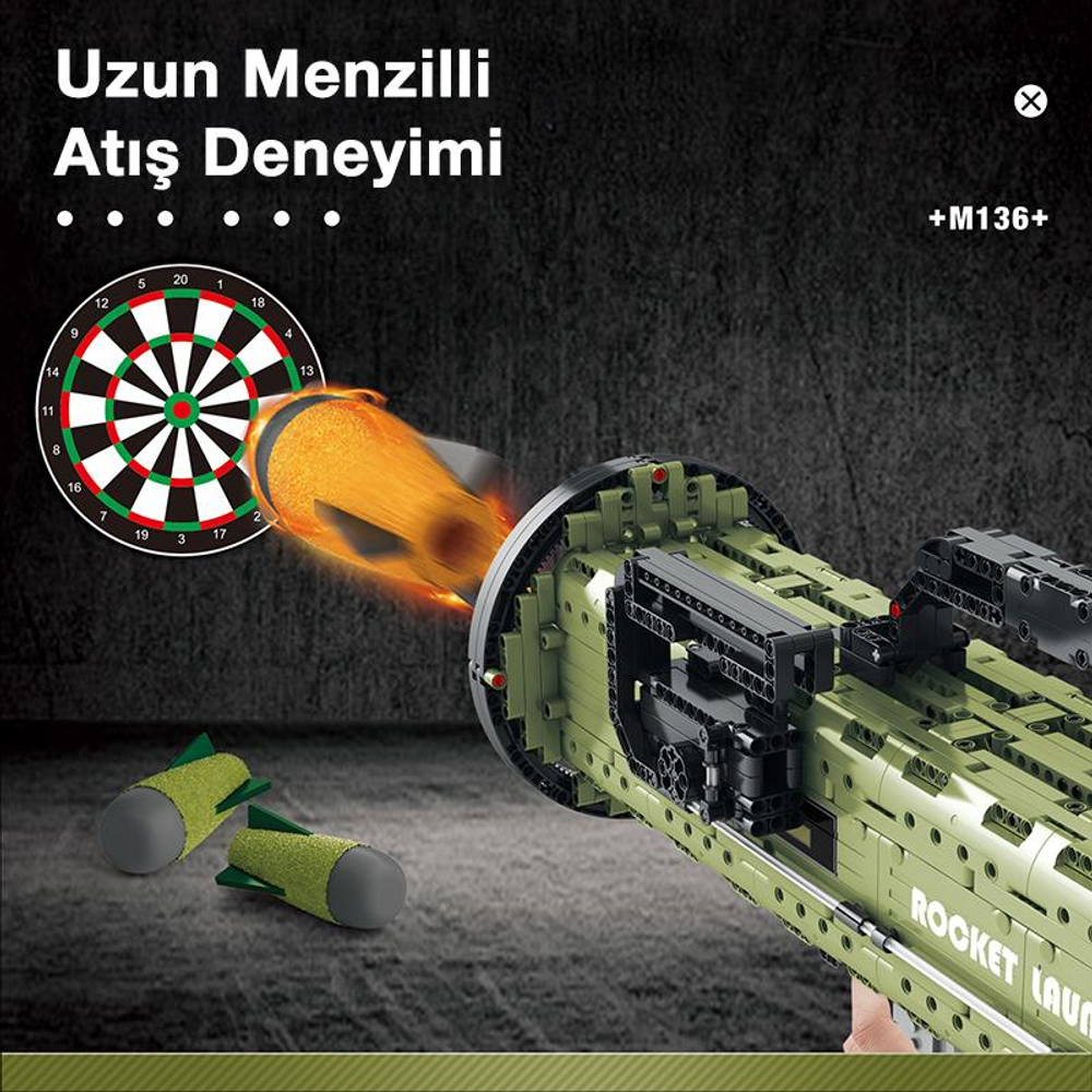 Oyuncak roketatar, dart tahtasına doğru bir mermi ateşliyor. İki yeşil roket önde yatıyor.