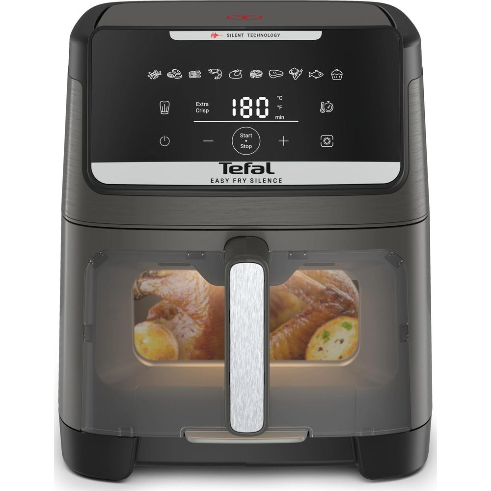 Una friggitrice ad aria Tefal che cuoce un pollo e patate all'interno della sua finestra trasparente.