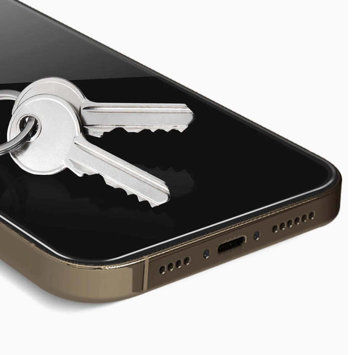 Twee zilveren sleutels rusten op een donker, reflecterend oppervlak, waarschijnlijk een smartphone-scherm.