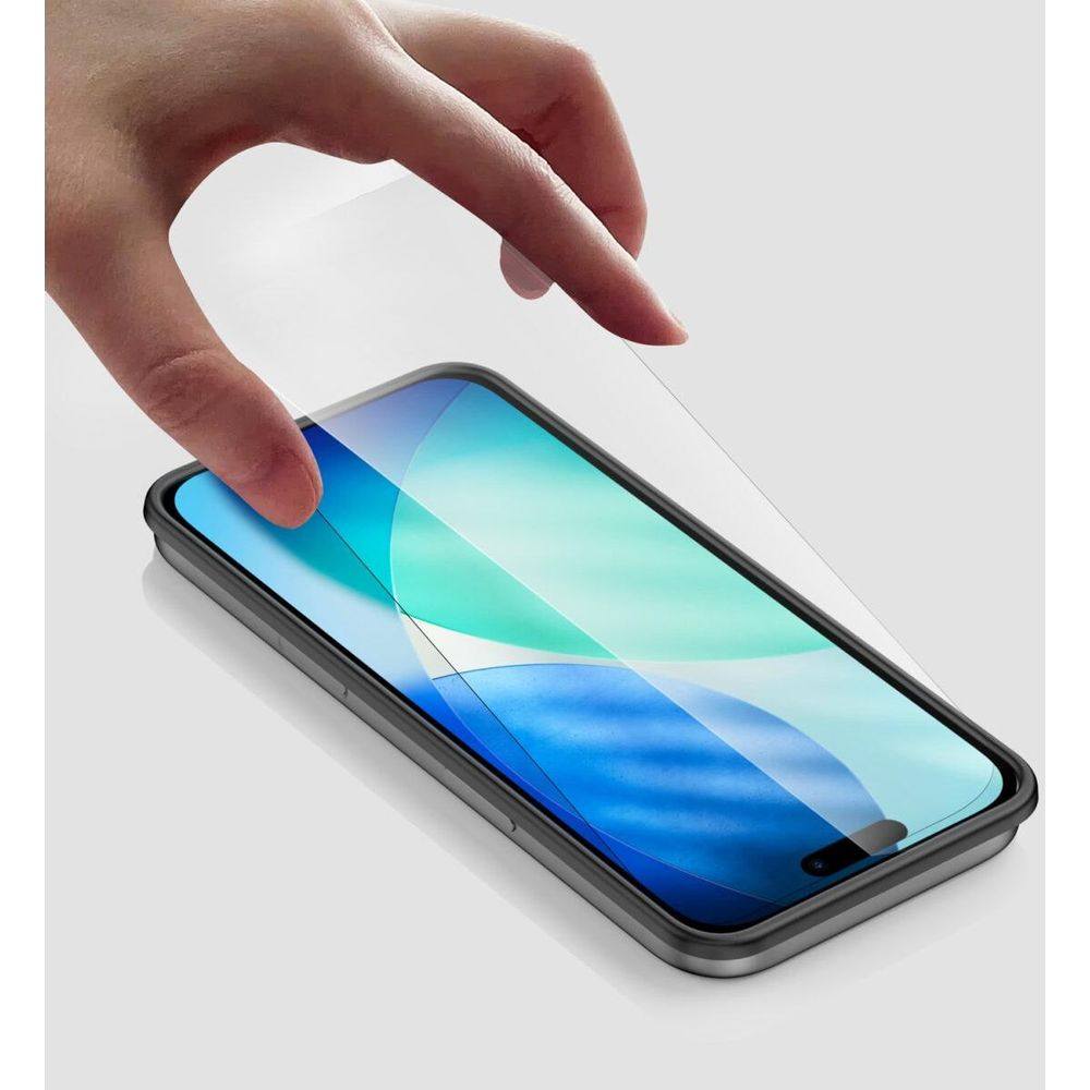A hand places a screen protector onto a smartphone with a blue and green wallpaper.