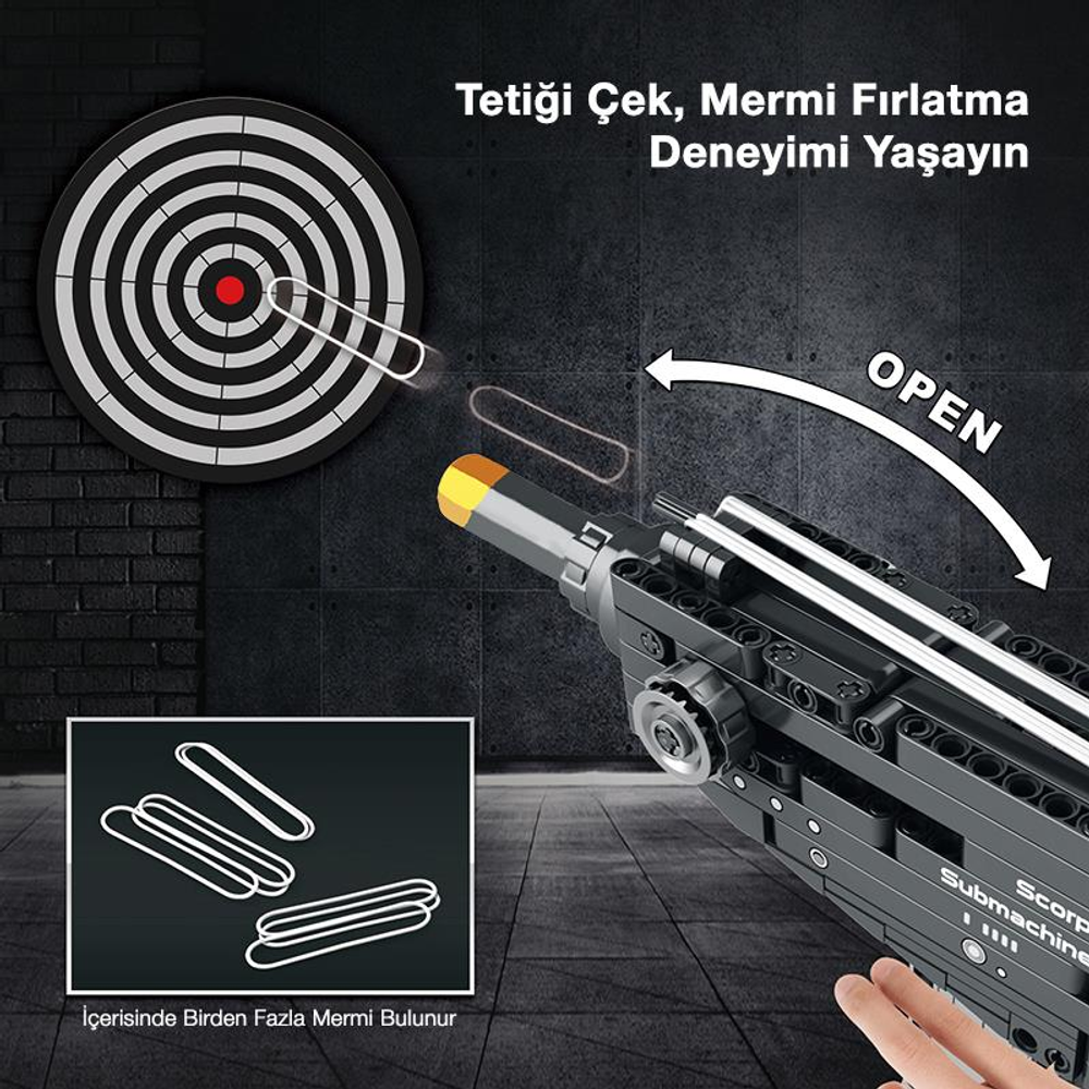 Oyuncak bir silah, dart tahtasına nişan alıyor. İçeride lastik bantlar gösteriliyor.