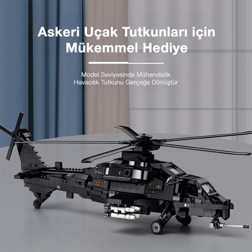 Kanatlarının altında füzeler bulunan siyah bir model helikopter masada duruyor.