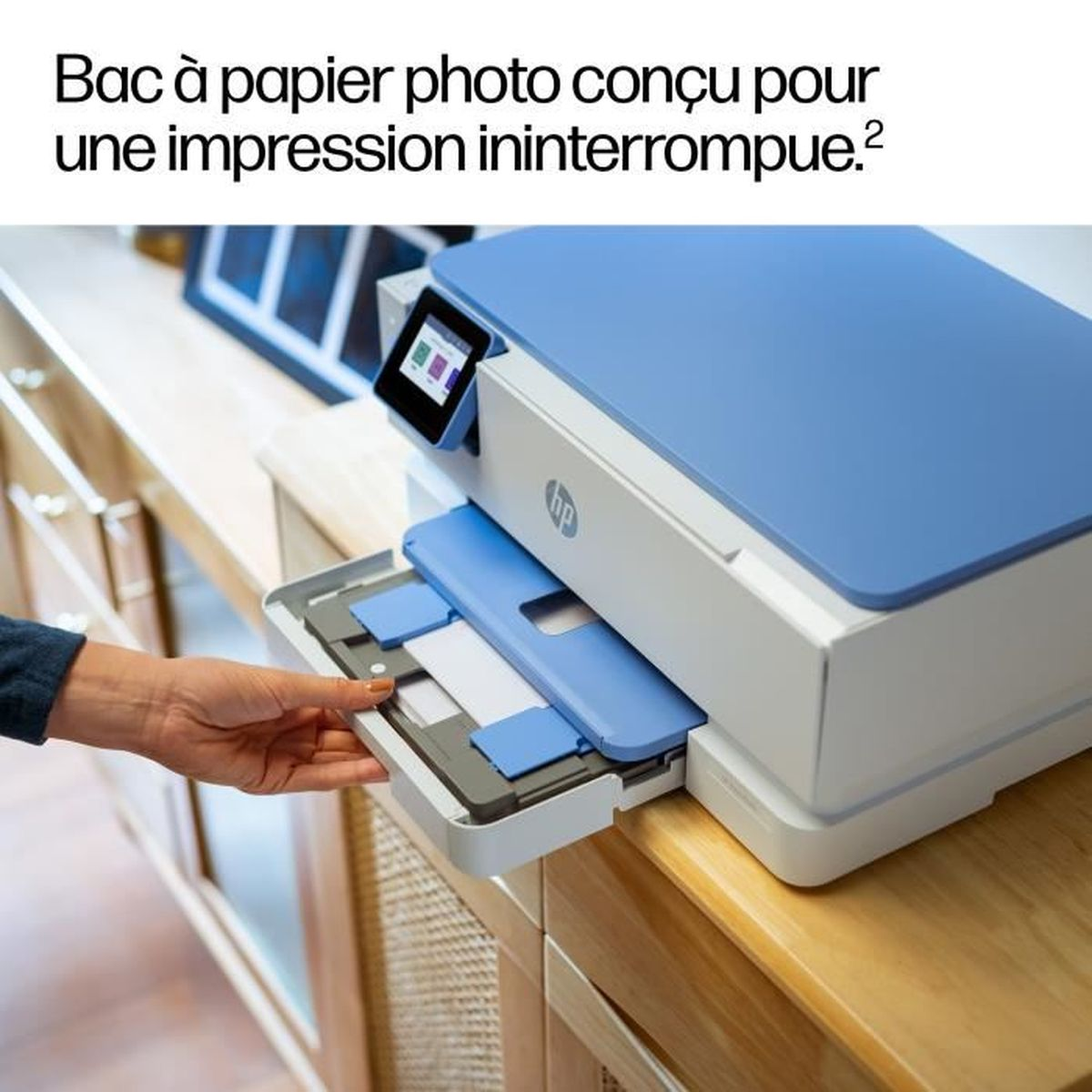 Una stampante HP blu, una mano inserisce un vassoio carta.