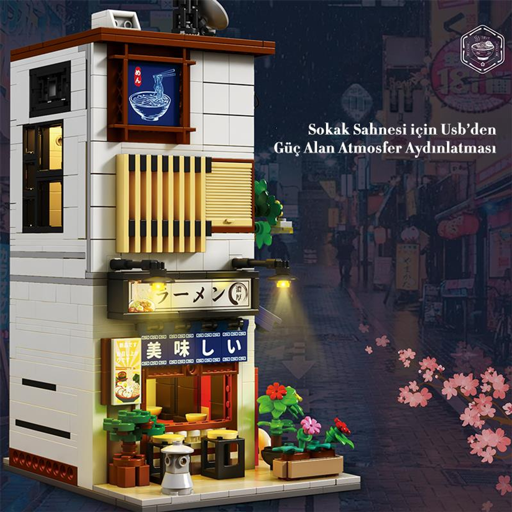 Işıklı tabelalara sahip, geceleyin bir Japon restoranının Lego modeli.