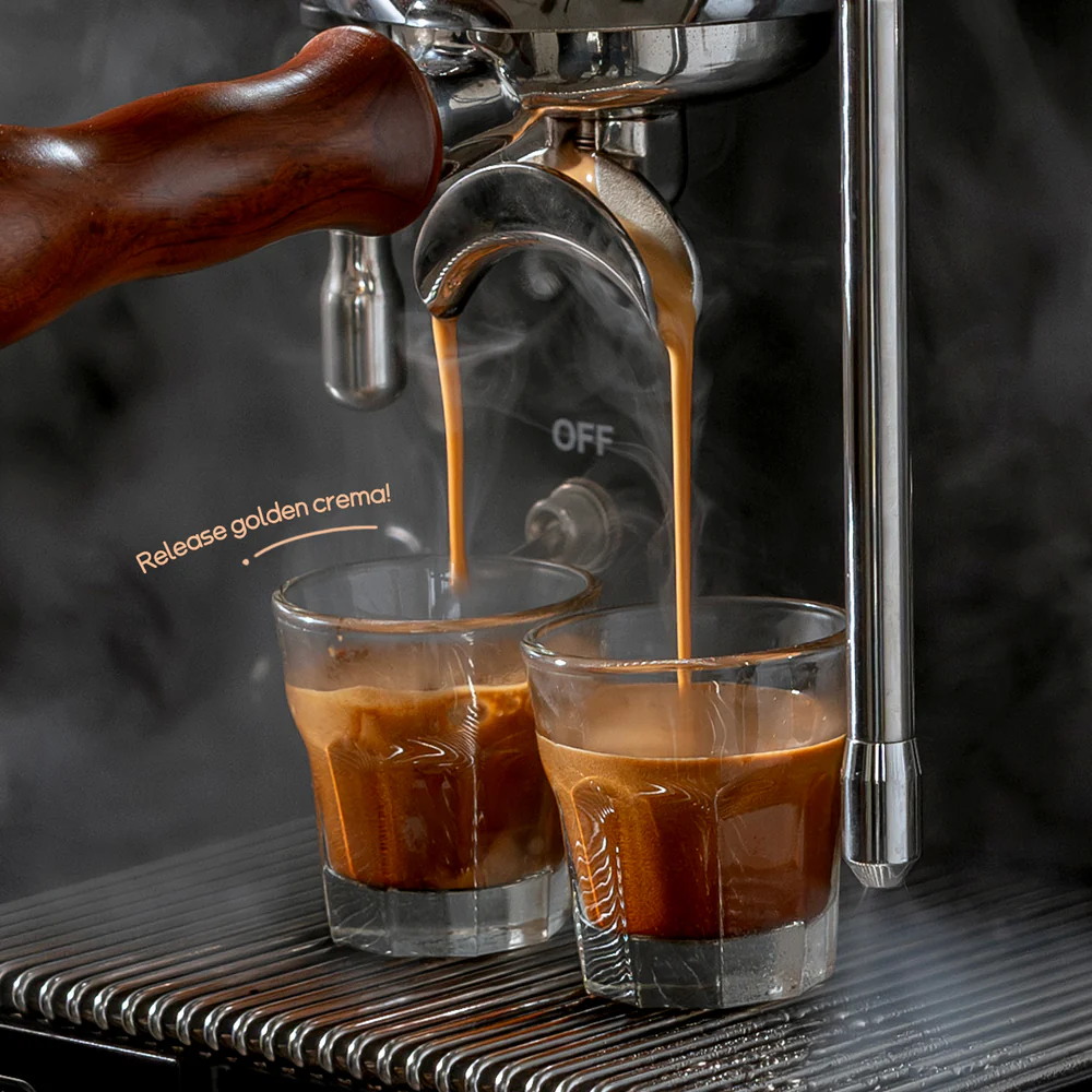 El espresso se vierte en dos vasos, el vapor se eleva.